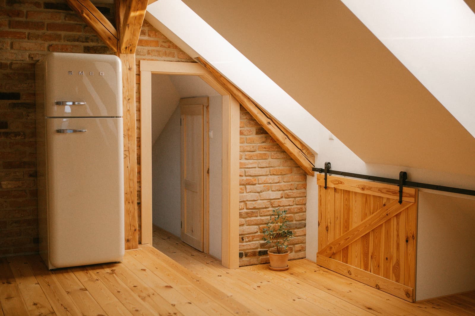 An attic loft space with storage boxes between roof beams