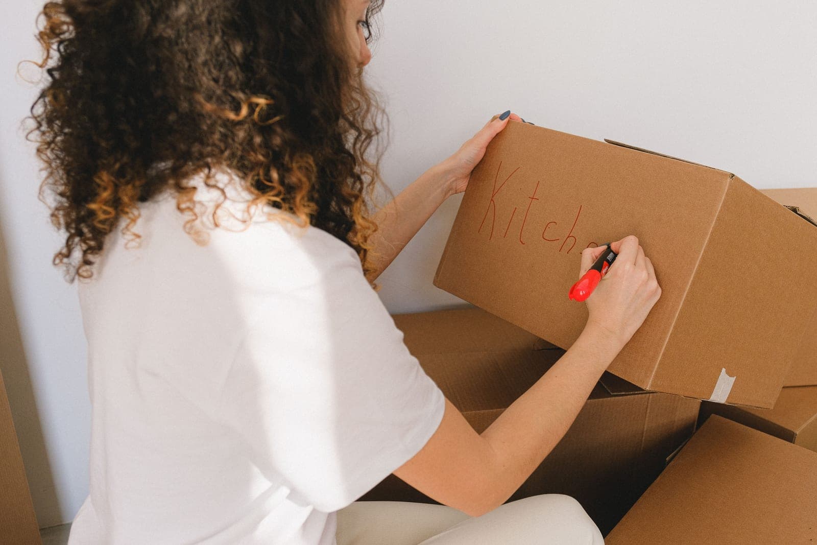 Writing a label on a storage box with a marker
