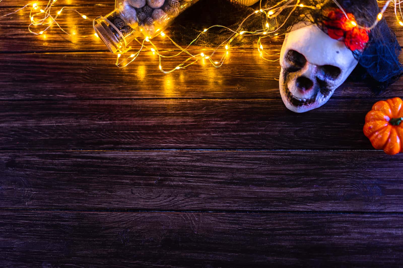 A coiled string of Christmas lights on a wooden surface
